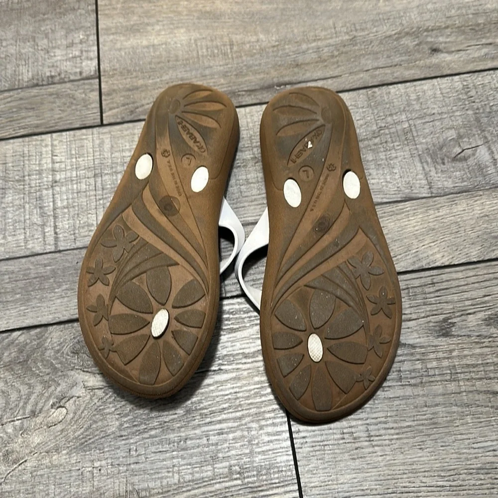 Okabashi flip flops with white straps and neutral color bottoms
